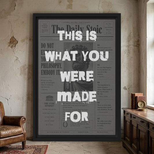Framed motivational canvas with text on a wall in a room with a leather chair and wooden desk.